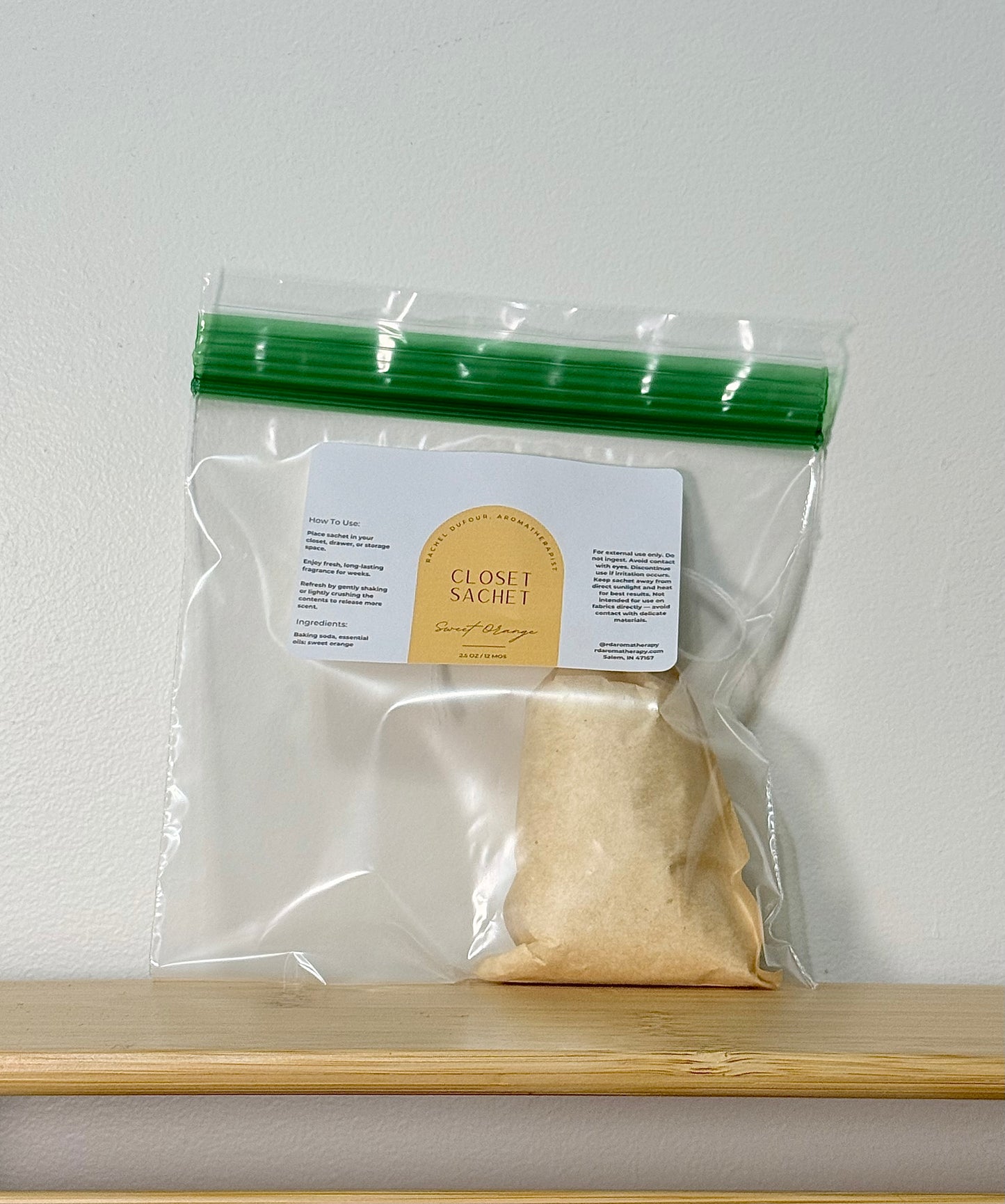 Clear plastic bag with a gold packet and label on a white background