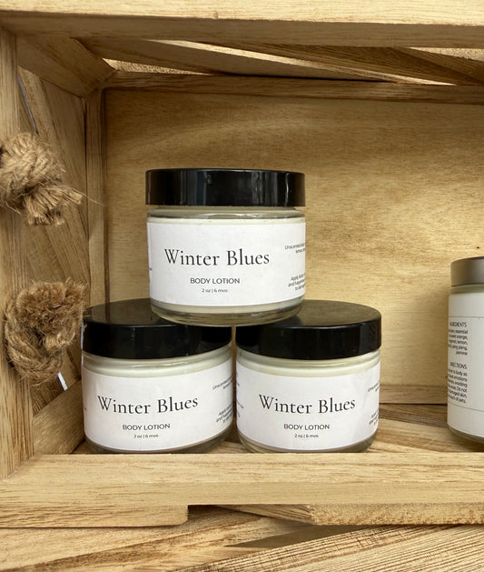 Jars of 'Winter Blues' body lotion on a wooden shelf