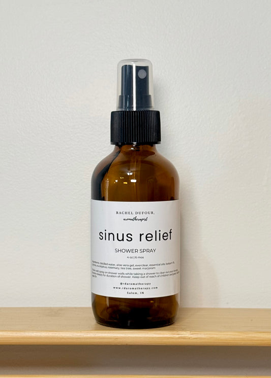 Brown spray bottle labeled 'sinus relief' on a white shelf with a white background