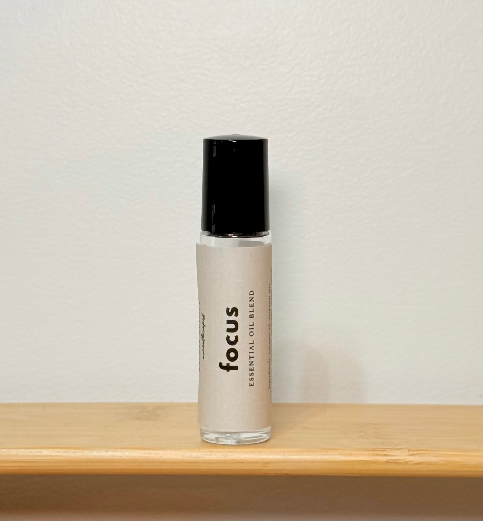 Bottle labeled 'focus' on a wooden surface with a neutral background