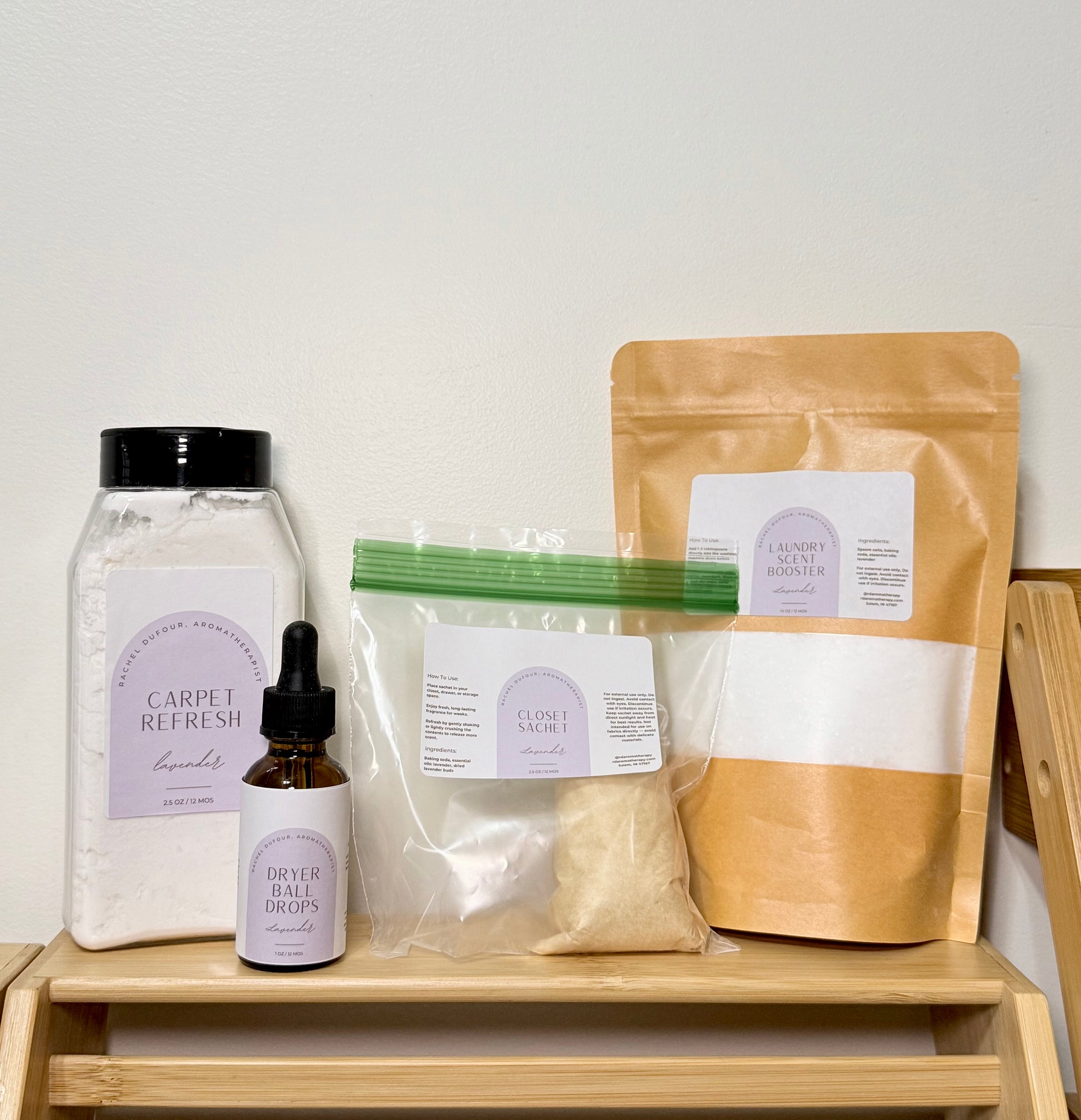 Set of cleaning products including a jar, bottle, and bags on a wooden shelf with a white background.