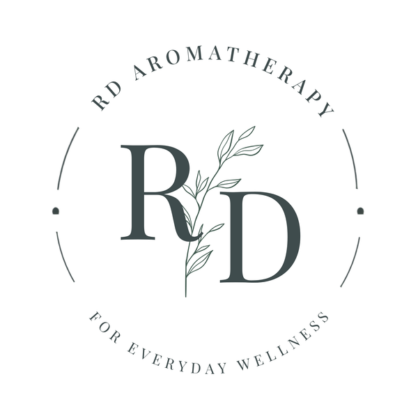 A circular logo design featuring the initials 'RD' with a botanical leaf branch running through them, surrounded by the text 'RD AROMATHERAPY' at the top and 'FOR EVERYDAY WELLNESS' at the bottom, on a plain white background.